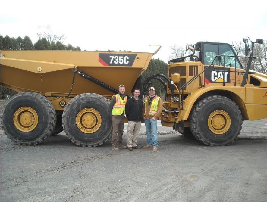 Team members from Schlouch & Foley with Schlouch’s new Cat 735C articulated truck